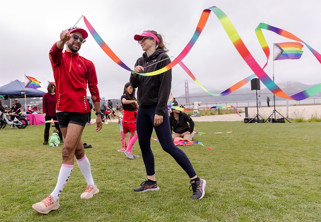 Smiling participants twirl rainbow gymnastics ribbons at the Fantastic Field Day outdoor event at Presidio Tunnel Tops. Photo by Brittany Hosea-Small